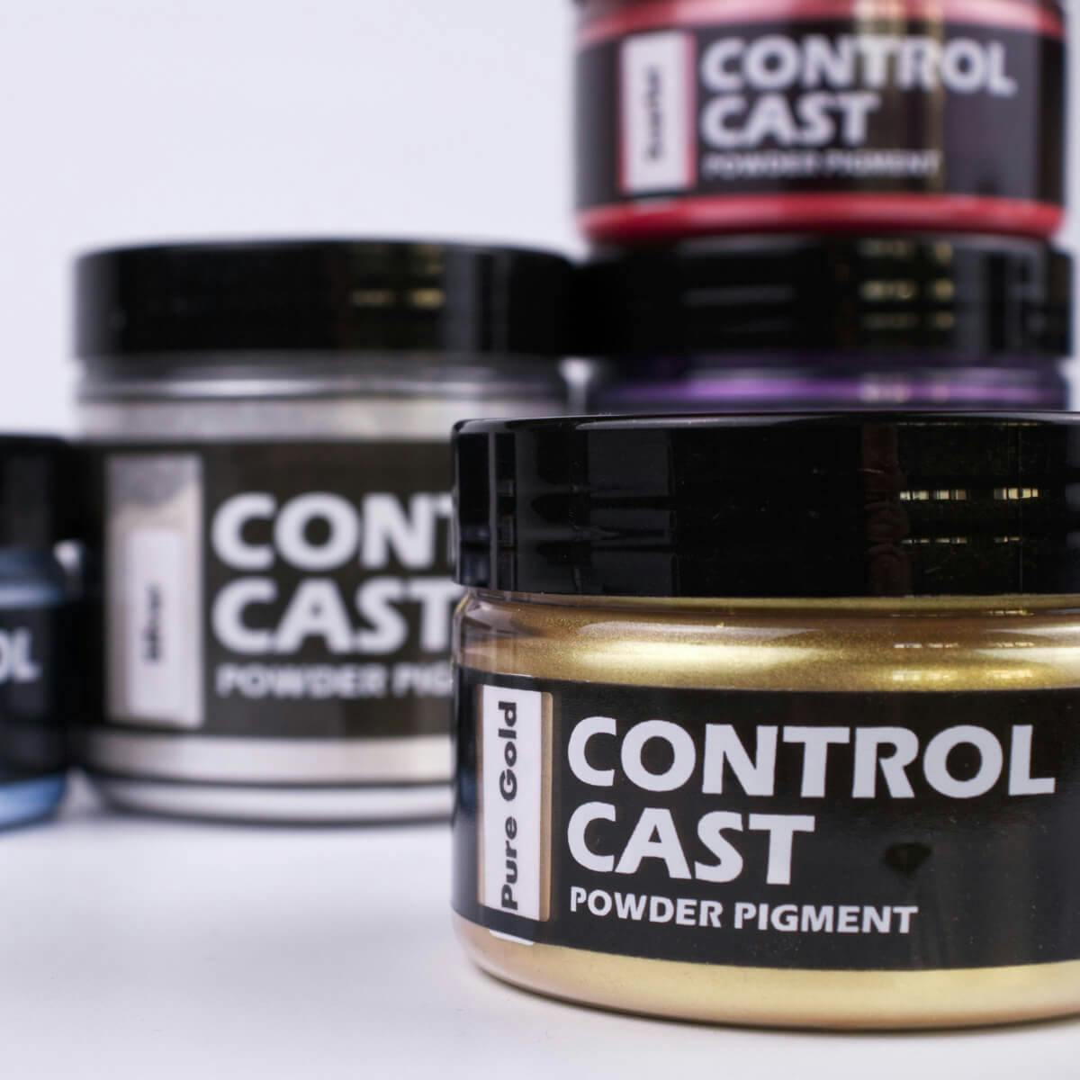 Close-up of Control Cast powder pigments with pure gold in the foreground